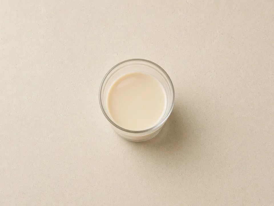 Oat milk for 12 months+: unsweetened, fortified oat drink in an open cup